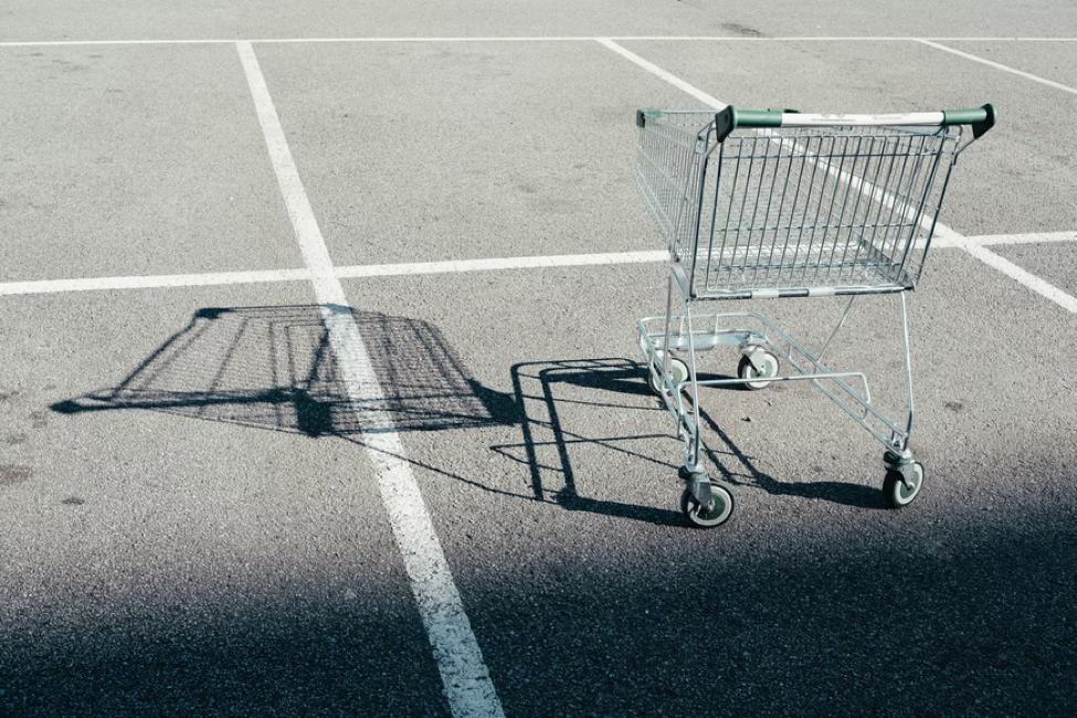 an empty shopping cart in a parking space