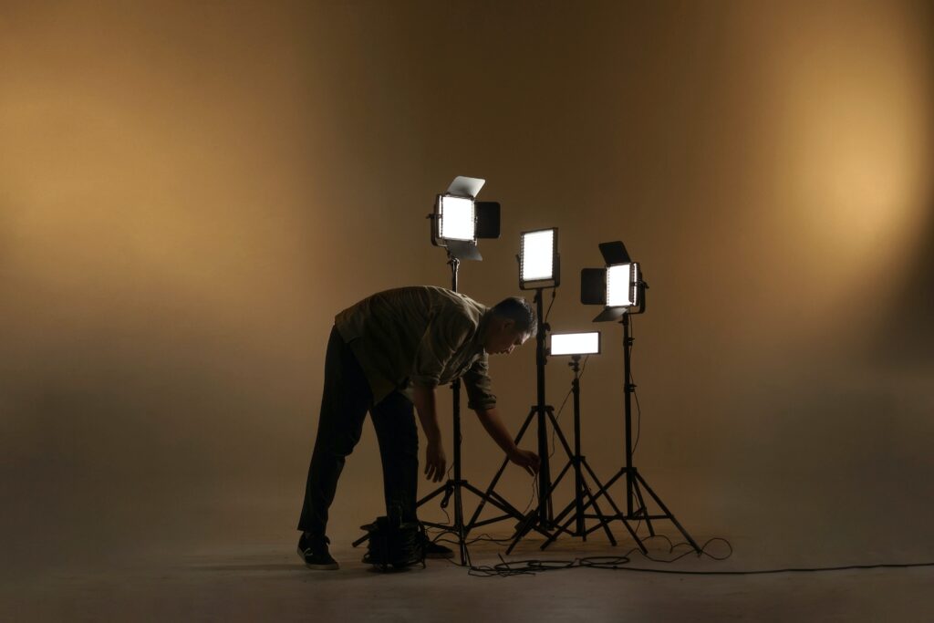 A man is setting up the lighting for a photoshoot.